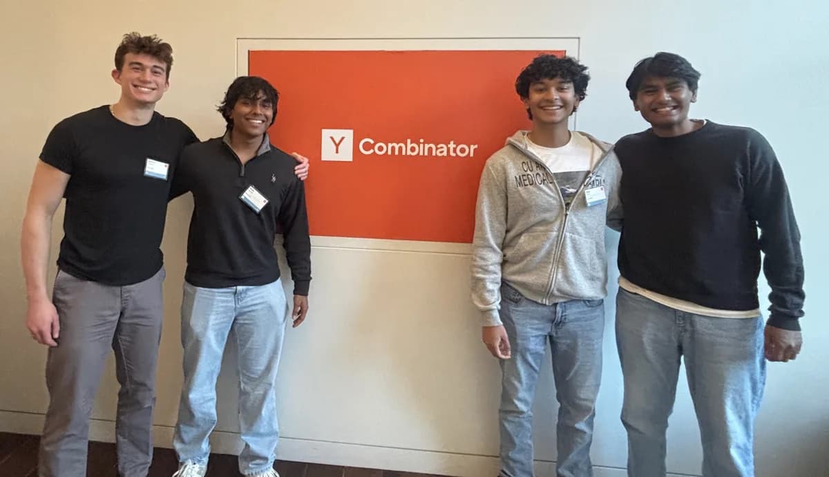 The four Knowlify founders standing together in front of a Y Combinator sign.